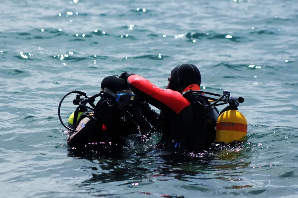 Divers practising a surface rescue exercise in full gear on the Rescue Diver course in Malta